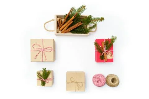 Flat lay craft boxes, rope and wooden box with cinnamon and pine tree on white Stock Photos