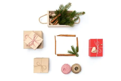Flat lay craft boxes, rope and wooden box with cinnamon and pine tree on white Stock Photos
