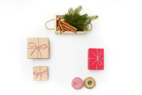 Flat lay craft boxes, white and red rope and box cinnamon and pine tree on white Stock Photos