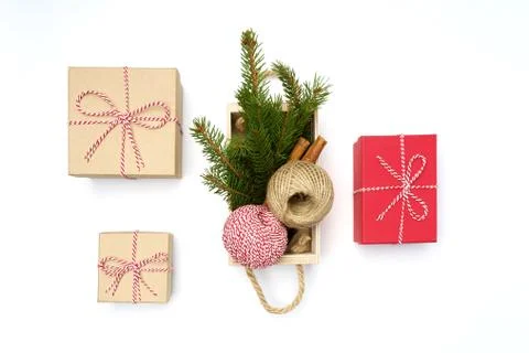 Flat lay craft boxes, white and red rope and box cinnamon and pine tree on white Stock Photos