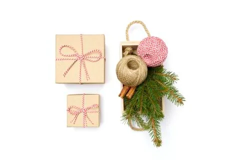 Flat lay craft boxes, white and red rope and box cinnamon and pine tree on white Stock Photos