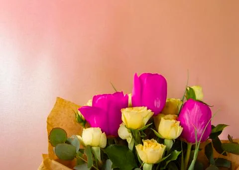 Flat lay creative layout is made with red and yellow flowers on pink backgrou Stock Photos