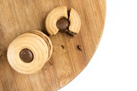 Flat lay crisp biscuits topped with chocolate cream on the wooden board Stock Photos