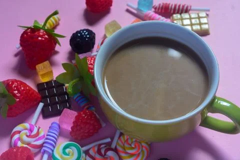 Flat lay a cup of coffee and chocolate, candies and cotton candy as a frame Foto stock