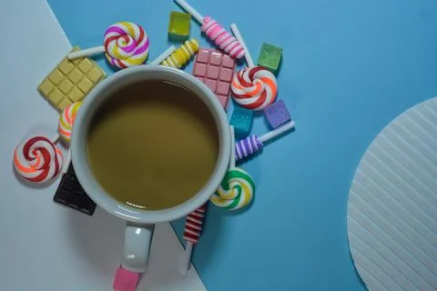 Flat lay a cup of coffee and chocolate, candies and cotton candy as a frame Foto stock