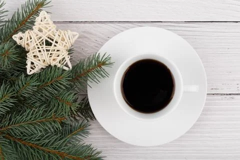 Flat lay with a cup of coffee on white rustic table decorated with Christmas Stock Photos