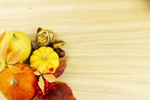 Flat lay with decorative pumpkins, leaves and wooden surface. Stock Photos