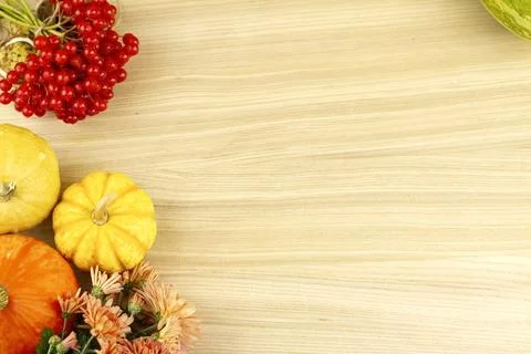 Flat lay with decorative pumpkins, leaves and red berries. Stock Photos