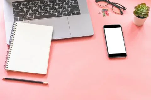 Flat lay design of workspace desk with laptop, blank notebook, smartphone, pe Stock Photos