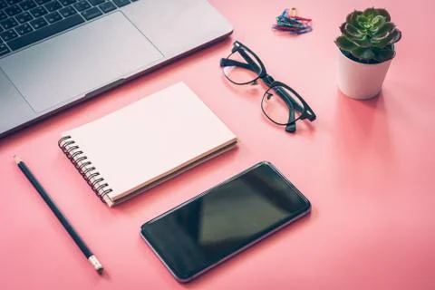 Flat lay design of workspace desk with laptop, blank notebook, smartphone, pe Stock Photos