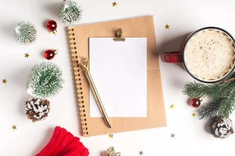 Flat lay of Desktop blank note pad with cup of coffee and Christmas decoratio Stock Photos