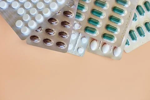 Flat lay different blister pack of Medical pills on orange background Stock Photos