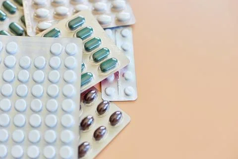Flat lay different blister pack of Medical pills on orange background Stock Photos