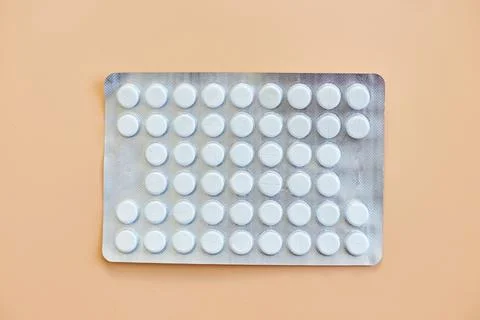 Flat lay different blister pack of Medical pills on orange background Stock Photos