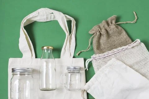 Flat lay different zero waste products green background Stock Photos