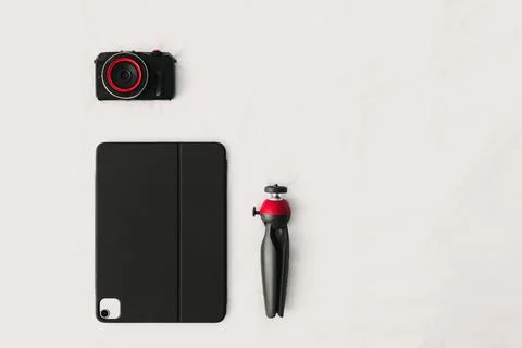 Flat lay of digital equipments of camera tablet and tripod. Stock-Fotos