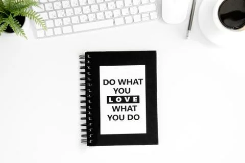Flat lay with do what you love what you do motivational quote on diary, computer Photos