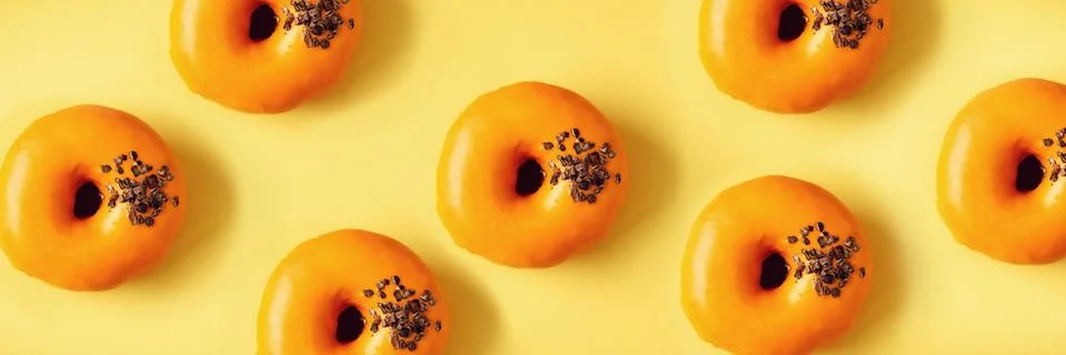 Flat lay donuts pattern on pastel orange background. Top view. Square crop Foto stock