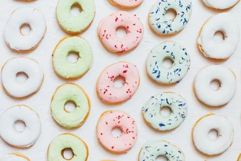 Flat lay donuts pattern on a white background. Stock Photos