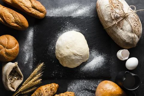 Flat lay dough bread black background Stock Photos