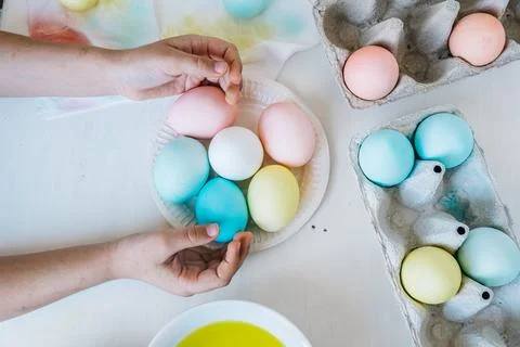 Flat lay Easter background. Close up Child holding colorful dyed easter eggs in Stock Photos