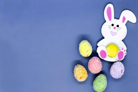 Flat lay Easter background. Toy rabbit and colorful painted eggs Stock Photos