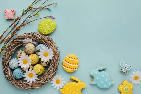 Flat lay easter eggs basket with chamomile flowers bunny shape Stock Photos