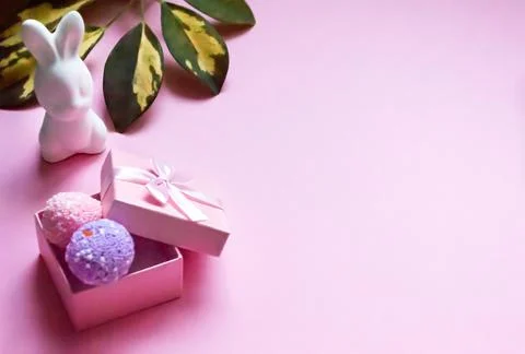Flat lay Easter pink background with bunny and eggs in a box Stock Photos