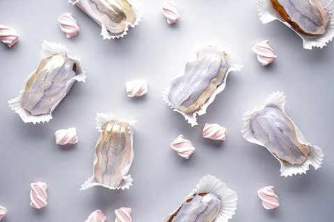 Flat lay eclairs with marshmallows on a gray background. French dessert. Stock Photos