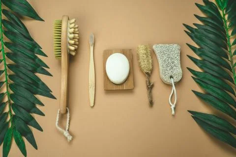 Flat lay eco friendly spa kit, massage brush, bamboo toothbrush, pumice, wood Stock Photos