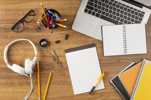 Flat lay educational elements arrangement with empty notepad Stock Photos