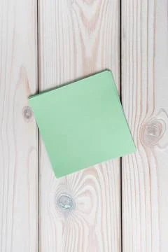 Flat lay of empty blank green sticker sticky note on grey wooden table. Note, Stock Photos