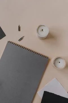 Flat lay empty blank paper sheet, spiral notepad and stationery on beige back Stock Photos