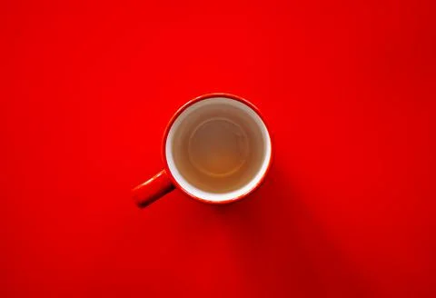 Flat lay of empty red coffee cup on red background Stock Photos