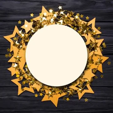 Flat lay empty round frame of big and small stars of confetti. Golden beads Stock Photos