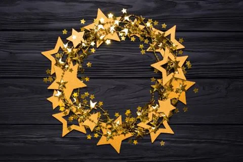 Flat lay empty round frame of big and small stars of confetti. Golden beads Stock Photos
