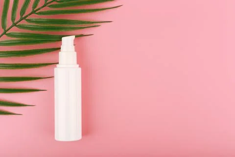 Flat lay with face cream or lotion for daily skin care against pink background Stock Photos