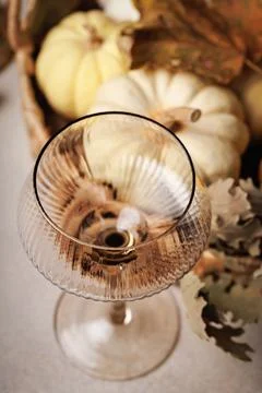 Flat lay of fall pumpkins and wine glass decor Stock Photos