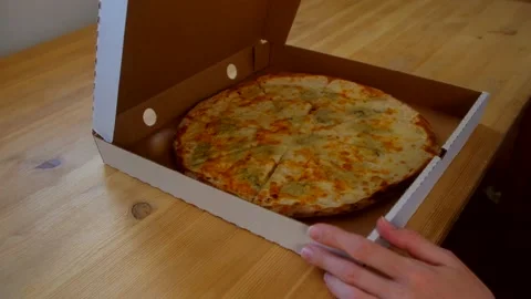 Flat lay - female opening box with 4 cheese pizza. Video stock 239758584
