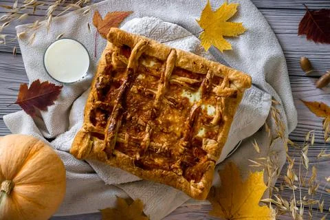 Flat lay festive pumpkin pie, glass of milk, autumn season Stock Photos