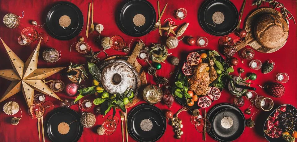 Flat-lay of festive table with roasted turkey, fruits and decorations Stock Photos