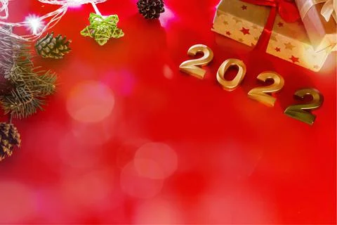 Flat lay format greeting card happy new year, numbers 2022 and gifts on red b Stock Photos