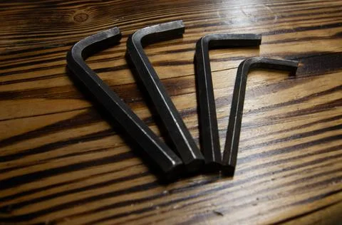 Flat lay of four imbus hex keys on a wooden texture background Stock Photos