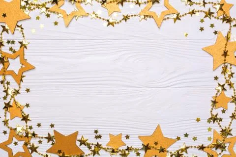 Flat lay frame of big and small stars of confetti. Golden beads of shine star Stock Photos