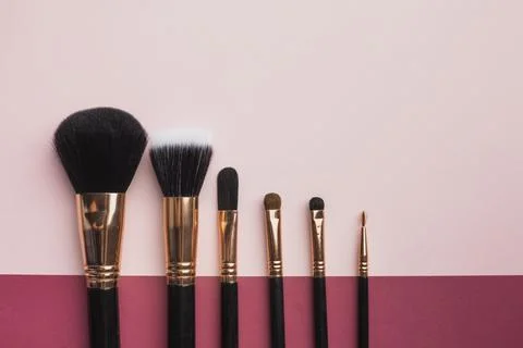 Flat lay frame with make up brushes pink background Beautiful photo Stock Photos