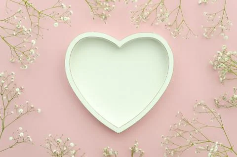Flat lay. Frame shaped wooden heart with copy space for your text and flowering Stock Photos