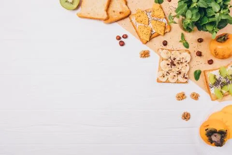 Flat lay frame of sweet fruit toast ingredients with copy space Stock Photos
