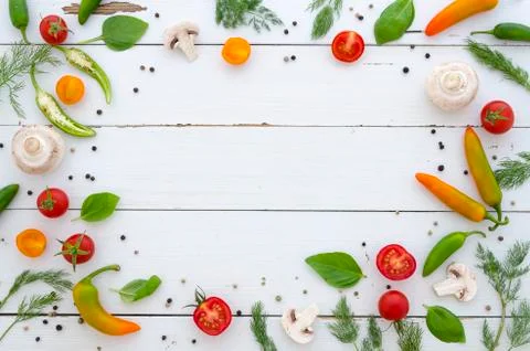 Flat lay Frame of vegetables and spices on white wooden background Stock Photos