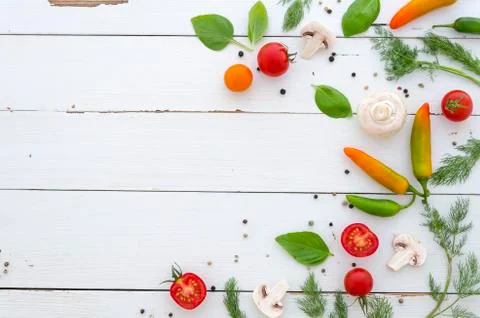 Flat lay Frame of vegetables and spices on white wooden background Stock Photos