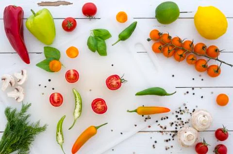 Flat lay Frame of vegetables and spices on white wooden background Stock Photos